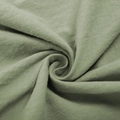 Close-up of light green cotton linen fabric texture with elegant spiral weave detail - XS / Dresses / Light Green