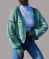 Close-up of light green knit cardigan with dark green stripes and ribbed cuffs on a model - XL / Green