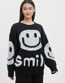 Detail of white jacquard smiley face and smile text on a black oversized knit sweater - S / Black