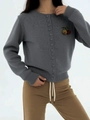 Detail of grey knit cardigan featuring delicate cherry embroidery and ribbed texture - One Size / Medium Grey