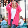 Detailed knit texture of a loose-fit magenta hooded cardigan with wide batwing sleeves - Rose Red