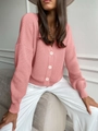 Dettaglio di cardigan in maglia con scollo a V, bottoni bianchi e trama a coste - Taglia unica / Rosa