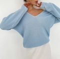 Close-up of the light blue chunky knit texture and ribbed cuffs of this V-neck sweater - Pale Blue