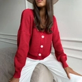 Detail of red cable knit cardigan showing deep V-neckline and white button closure - One Size / Tops / Red