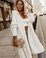 Close-up of white oversized hooded knit cardigan featuring chunky knit and large pockets - S / Off-white
