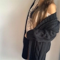 Detail view of the chunky cable-knit pattern on a navy blue long cardigan for women - Black