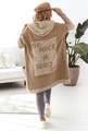 Detail of knit cardigan showing jacquard Be Nice text and star pattern on the back - Khaki