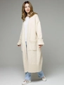 Detail of loose knit cardigan texture with oversized pockets and ribbed cuffs in beige - Beige