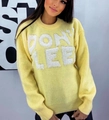 Close-up of yellow knit sweater featuring white chenille DON'T LEE lettering detail - Yellow