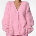 Detail of pink mink cashmere V-neck cardigan featuring plush texture and matching buttons - Pink