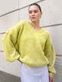 Detailed texture of neon yellow oversized V-neck knit sweater with ribbed cuffs and hem - Light Yellow