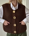 Close-up of deep brown chunky knit vest with four vintage gold embossed buttons - Coffee