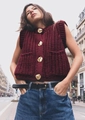 Detail of burgundy chunky knit vest featuring four decorative gold metal buttons - Burgundy