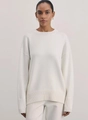 Detail shot of a white knit sweater showing the crewneck and soft ribbed wool texture - M / White