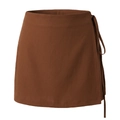 Detailed close-up of side tie fastening and texture on brown wrap mini skirt - Caramel color