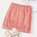 Detail view of pink plaid mini skirt featuring a stylish side slit and high waist - L / Pink