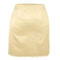 Detailed close-up of cream satin mini skirt featuring delicate white lace trim at the hem - S / Beige