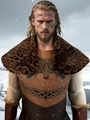 Viking warrior costume featuring leopard faux fur collar and Nordic knot leather vest - Dark Leopard Print