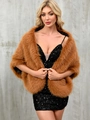Elegant brown faux fox fur shawl wrap styled over a black sequin dress for evening wear - Camel
