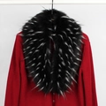 Close-up of fluffy black and white faux fur collar on red chunky knit cardigan - Black and White Jacquard