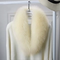 Detail of soft faux fox fur scarf in light beige on a hanger with high gloss finish - Beige