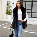 Women's black faux fur vest with a high collar and fluffy texture in an outdoor setting - S / Black