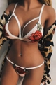 Detailed view of floral embroidery and strappy lace design on white lingerie set - S / Pink