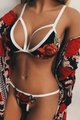 Close-up of elegant red rose embroidery on a black mesh lingerie set with white trim - S / Black