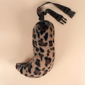 Detailed macro view of leopard print plush faux fur tail with adjustable waist strap - Leopard Print