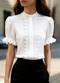 Close-up of white stand collar blouse featuring lace trim and ruffled puff sleeves - S / Tops / White