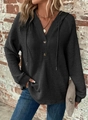 Detailed view of black waffle-knit fabric texture with V-neck button and hoodie drawstring - S / Black