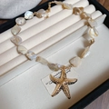 Bohemian style beaded shell necklace with a textured golden starfish charm - Gold-Starfish