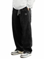 Detail of men's black corduroy pants with white drawstring and classic textile label - S / Black