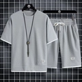 Dettaglio del tessuto a nido d'ape grigio e dell'orlo bianco a strati sul set da uomo - Taglia M / Top E Pantaloni / Grigio chiaro