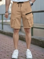 Detail of khaki cargo shorts featuring large flap pockets and adjustable drawstring waist - S / Khaki