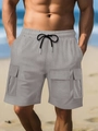 Detailed macro view of grey cargo shorts with elastic drawstring waist and utility pockets - Light Gray