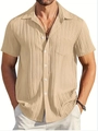 Detail of light beige men's cotton linen shirt showing vertical pleat texture and front pocket - Khaki