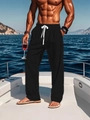 Close-up of black cotton linen pants with elastic waist and white drawstring on a yacht - S / Black