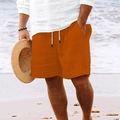 Detail of orange striped beach shorts with drawstring waist against a sandy shore - S / Red