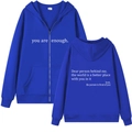 Detail of blue zip-up hoodie featuring white motivational text and soft fabric texture - S / Sapphire Blue