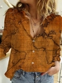 Detailed view of the vintage map print and pearl buttons on a women's long sleeve shirt - S / Tops / Coffee Map