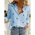 Close-up of light blue long-sleeve shirt with bird print and white buttons texture - S / Tops / Blue Floral Print