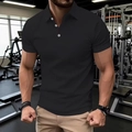 Close-up of black short sleeve polo shirt with white buttons in gym setting - S / Black