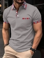 Detailed view of dark grey men's polo shirt with red and blue tartan plaid collar and pocket - S / Dark Gray