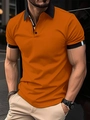 Detailed view of men orange polo shirt with black contrast collar and striped sleeve cuffs - M / Brown
