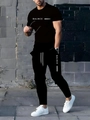 Outdoor street shot of men's black sports set with white BALNCE letters and stripe detail - S / Black