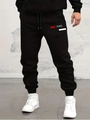 Detail view of black joggers with Paris print and drawstring waist on industrial background - S / PARIS Print-Black