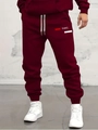 Detail of burgundy joggers with drawstring waist and PARIS logo print on thigh - S / PARIS Print-Red