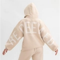 Back view of beige oversized hoodie featuring large white REDEEMED puff print text - Apricot (REDEEMED Print)