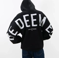 Close-up of the large white REDEEMED back print on a black oversized fleece hoodie - Black/White Icon